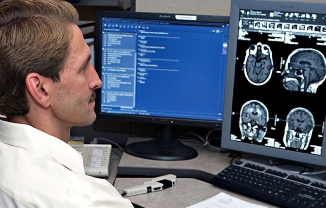 Doctor looking at scans on computer